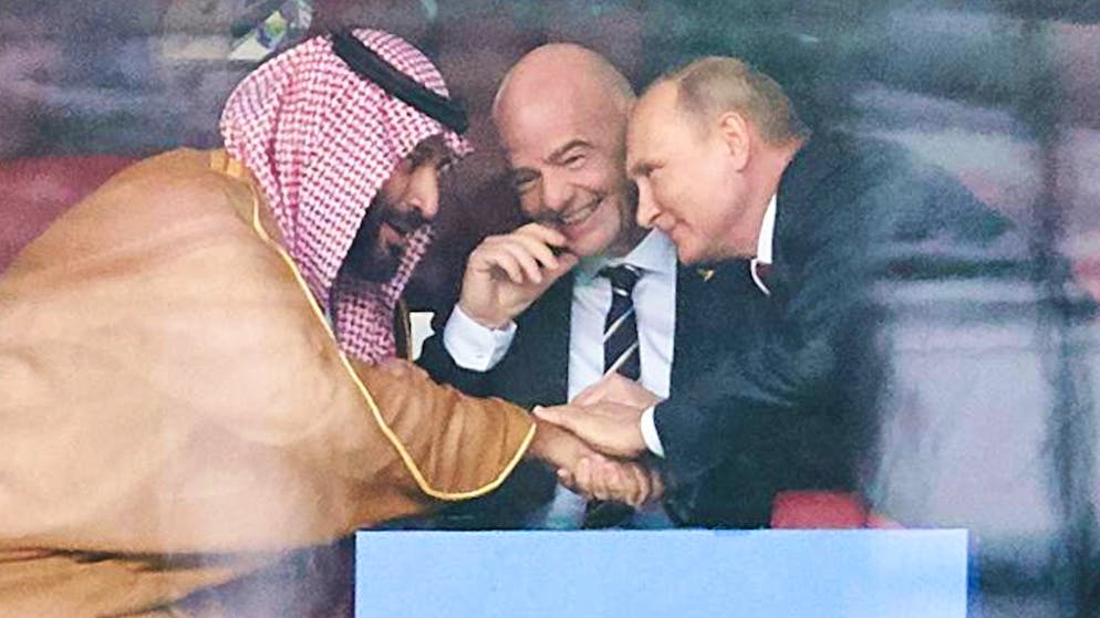 FIFA President Gianni Infantino (centre) at the 2018 World Cup in Russia in conversation with Mohammed bin Salman, Crown Prince of Saudi Arabia, and Russian ruler Vladimir Putin.