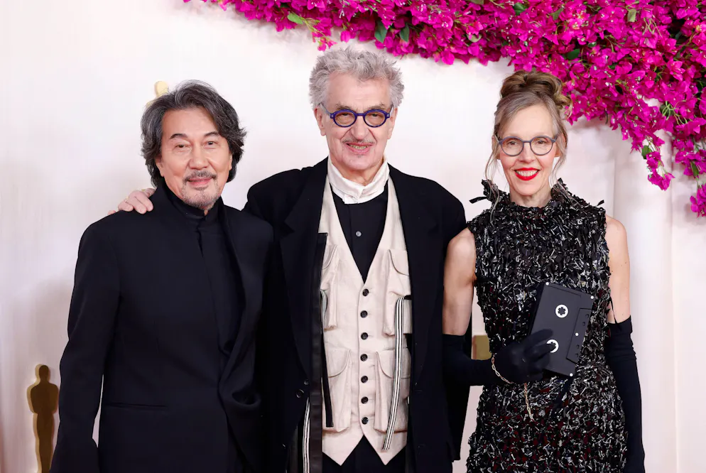 Oscars 2024: Die aussergewöhnlichsten Looks vom roten Teppich. Aussergewöhnlich ist auch Donata Wenders' Outfitwahl, die eine Hommage an ihren Gatten ist: Die Frau des deutschen Regisseurs Wim Wenders, der für einen Oscar nominiert war, kleidet sich in einer bodenlangen schwarzen Robe, die aus alten Videobändern ihres Mannes besteht. Eine VHS-Kassette als Clutch rundet den Look ab. 