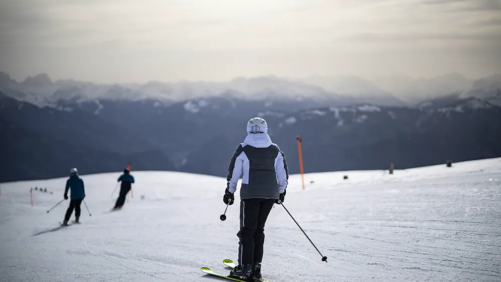 Skifahrer am 7. April 2024, dem letzten Tag der Saison, auf der Piste am Pizol, während Saharastaub die Luft eintrübt.