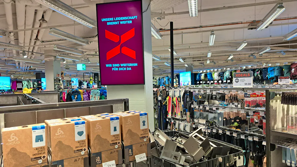 «Unsere Leidenschaft brennt weiter», heisst es auf dem SportX-Werbebildschirm in der Filiale. «Wir sind weiterhin für dich da.»