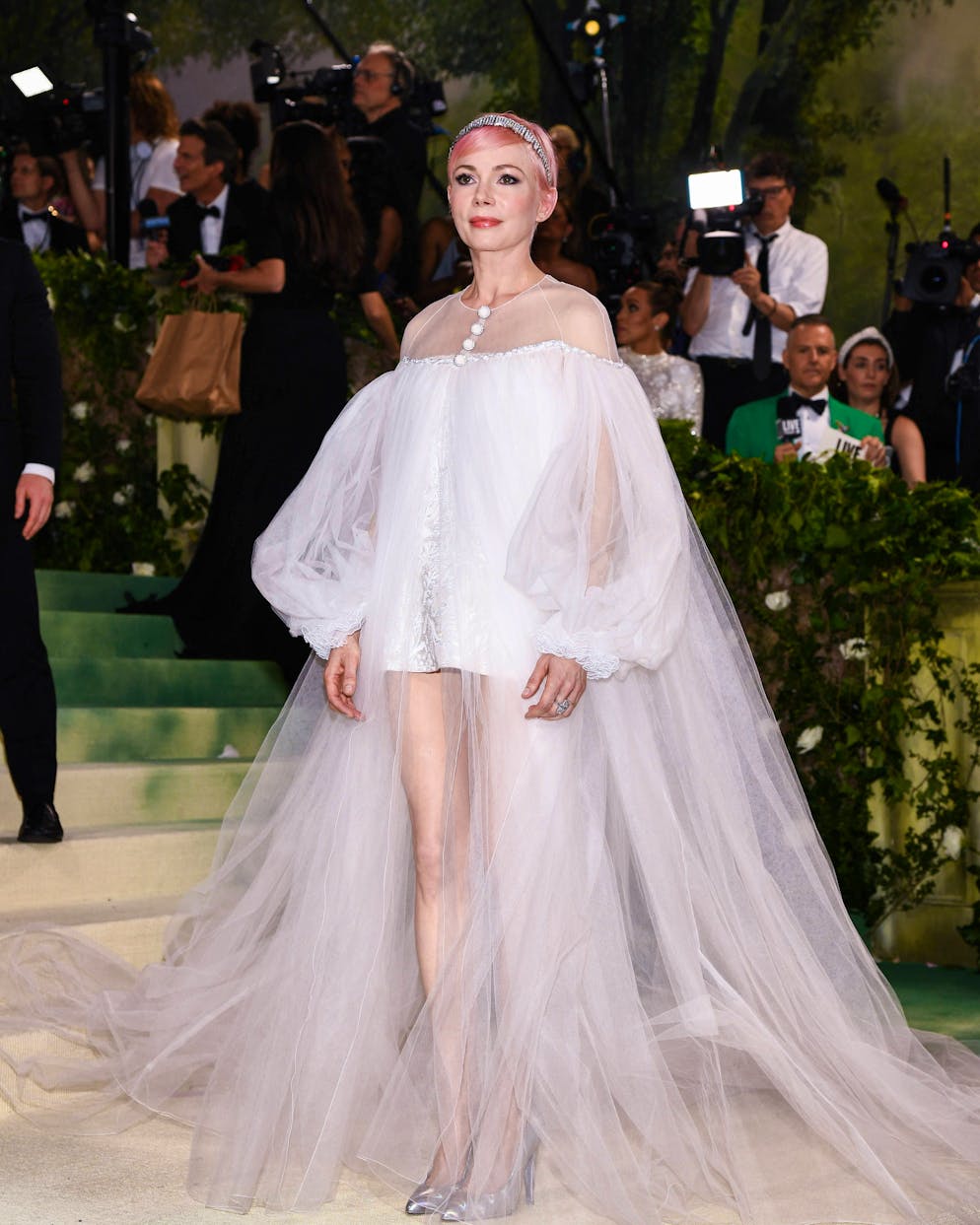 Die aufregendsten Looks der Met Gala. Nicht weniger eine Märchenweltfigur könnte Michelle Williams sein. In einem kurzen Chanel-Kleid mit langer Tüllschleppe überraschte sie zudem mit einem pastellpinken Pixie-Cut.
