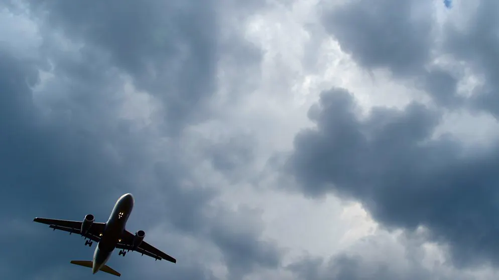 ARCHIV - Gewitterwolken türmen sich über einem Flugzeug auf. Foto: Federico Gambarini/dpa