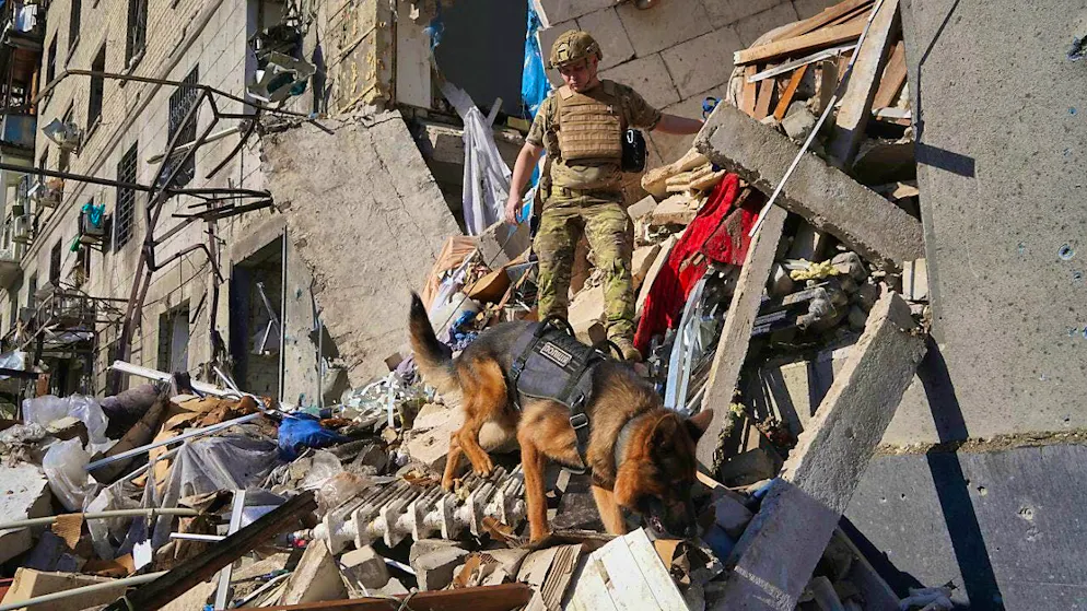 dpatopbilder - A rescue worker searches for victims in a destroyed residential building in Kharkiv. The city is repeatedly under fire. Photo: Andrii Marienko/AP/dpa