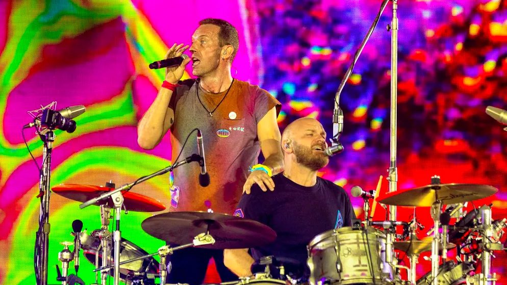 Singer Chris Martin (left) stands next to drummer Will Champion on stage. Coldplay and their ex-manager have filed a lawsuit against each other.