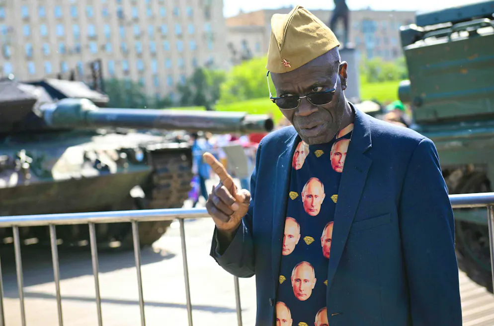 An African diplomat has his picture taken in Moscow on May 31 in front of Western weapons captured in Ukraine.