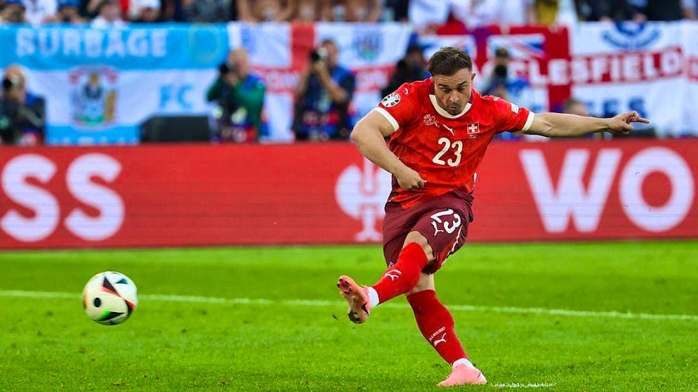 Xherdan Shaqiri converts his penalty against England - but Manuel Akanji doesn't