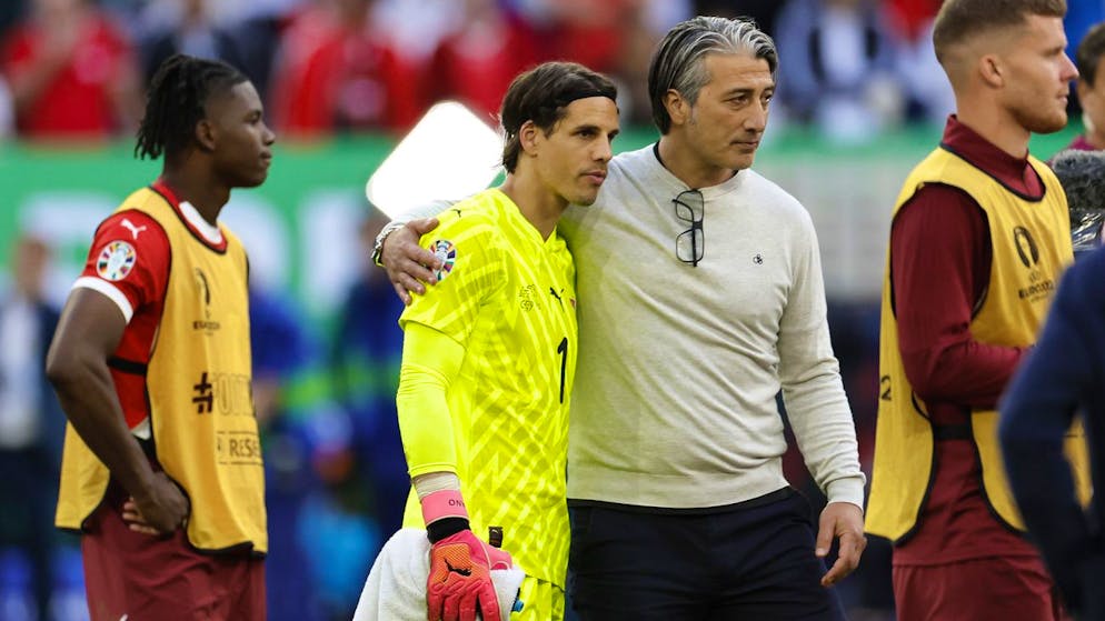 Switzerland's head coach Murat Yakin, center right, hugs his goalkeeper Yann Sommer beside Breel Embolo, left, and Nico Elvedi, right, after losing the penalty shoot-out of the quarter final match between England and Switzerland at the Euro 2024 soccer tournament in Duesseldorf, Germany, Saturday, July 6, 2024. (KEYSTONE/Peter Klaunzer)