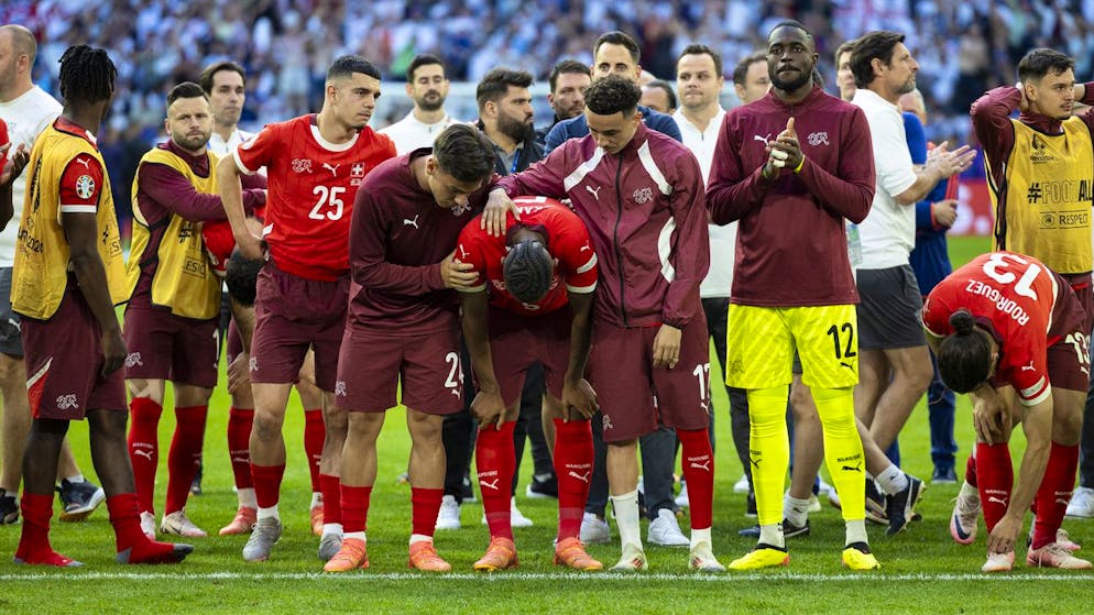 Switzerland's Zeki Amdouni, 3rd left, Switzerland's Ardon Jashari, center-left, Switzerland's Manuel Akanji, center, Switzerland's Ruben Vargas, center-right, Switzerland's goalkeeper Yvon Mvogo, Switzerland's goalkeeper Yvon Mvogo, 2nd right, react after losing the shootout during the overtime, during a quarter final match between England and Switzerland at the Euro 2024 soccer tournament in Duesseldorf, Germany, Saturday, July 6, 2024. (KEYSTONE/Peter Klaunzer)