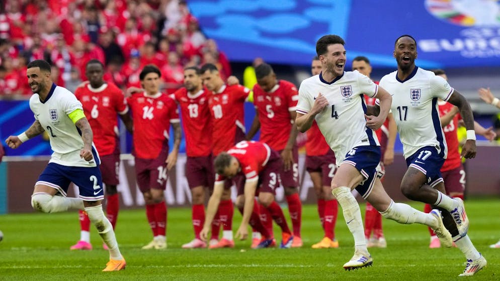 England players celebrate in front of Swiss players after Trent Alexander-Arnold scored the winning goal during the penalty shootout of a quarterfinal match between England and Switzerland at the Euro 2024 soccer tournament in Duesseldorf, Germany, Saturday, July 6, 2024. (AP Photo/Martin Meissner)