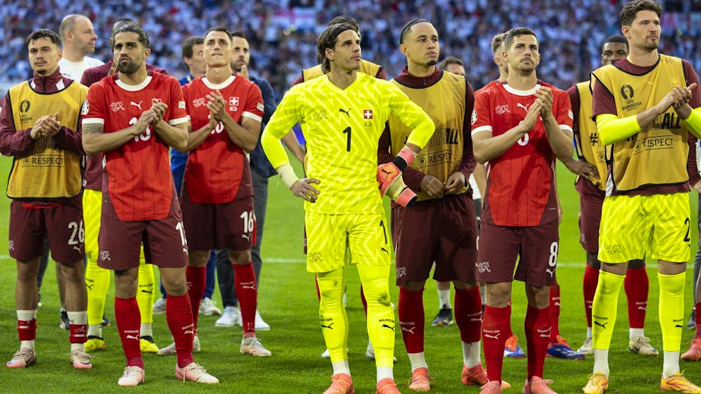 Switzerland's players with Fabian Rieder, Ricardo Rodriguez, Vincent Sierro, goalkeeper Yann Sommer, Noah Okafor, Remo Freuler and goalkeeper Gregor Kobel, from left to right, react after losing the shootout during the overtime, during a quarter final match between England and Switzerland at the Euro 2024 soccer tournament in Duesseldorf, Germany, Saturday, July 6, 2024. (KEYSTONE/Peter Klaunzer)