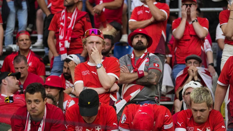 Switzerland supporters react after their team lost in the quarterfinal match against England at the Euro 2024 soccer tournament in Duesseldorf, Germany, Saturday, July 6, 2024. (AP Photo/Thanassis Stavrakis)