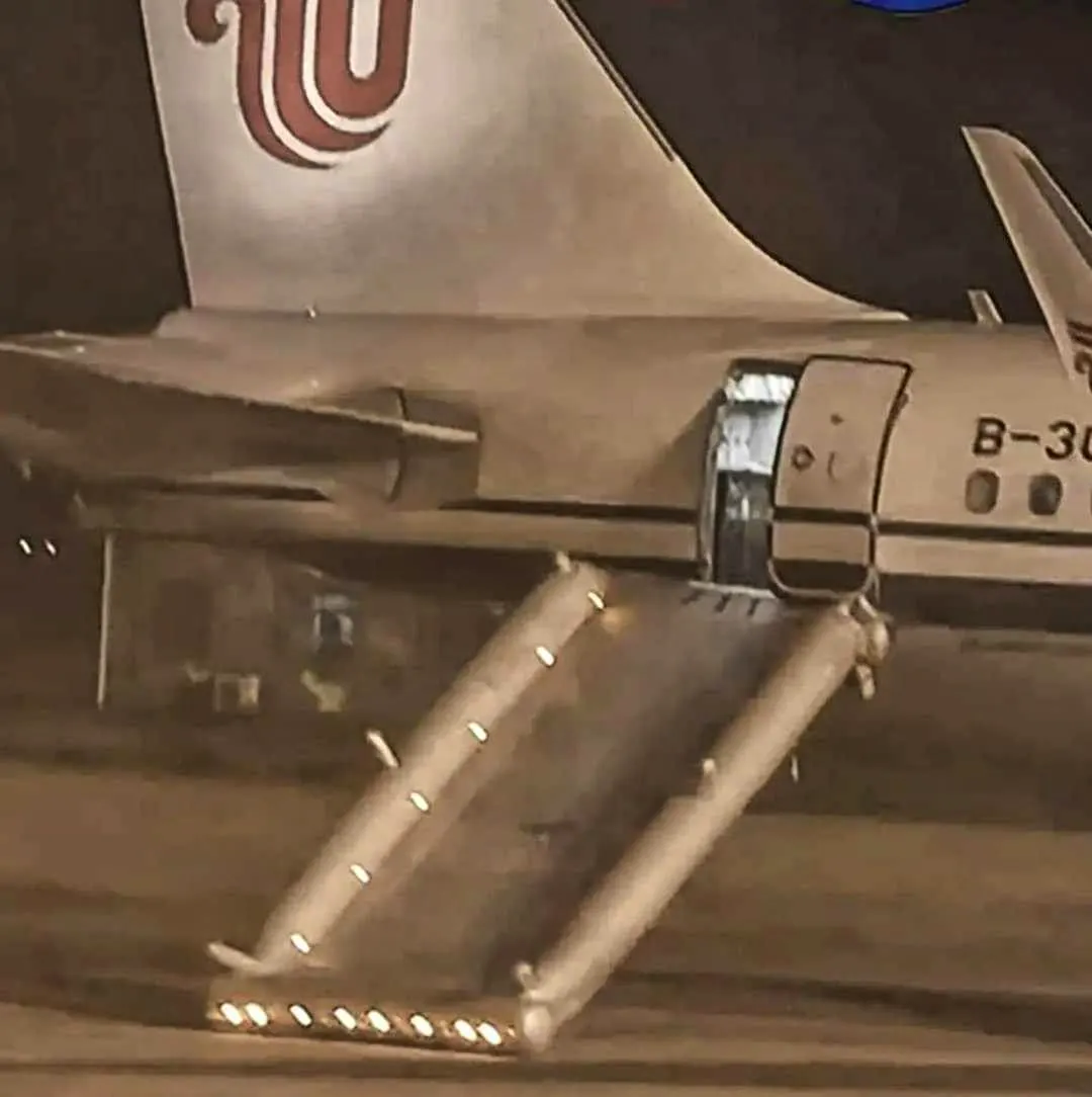 First flight. Woman activates emergency slide on airplane because she has to go to the toilet