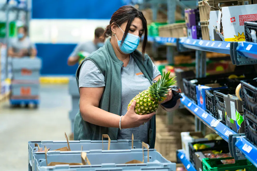 A Migros employee in Pratteln puts together a customer order.