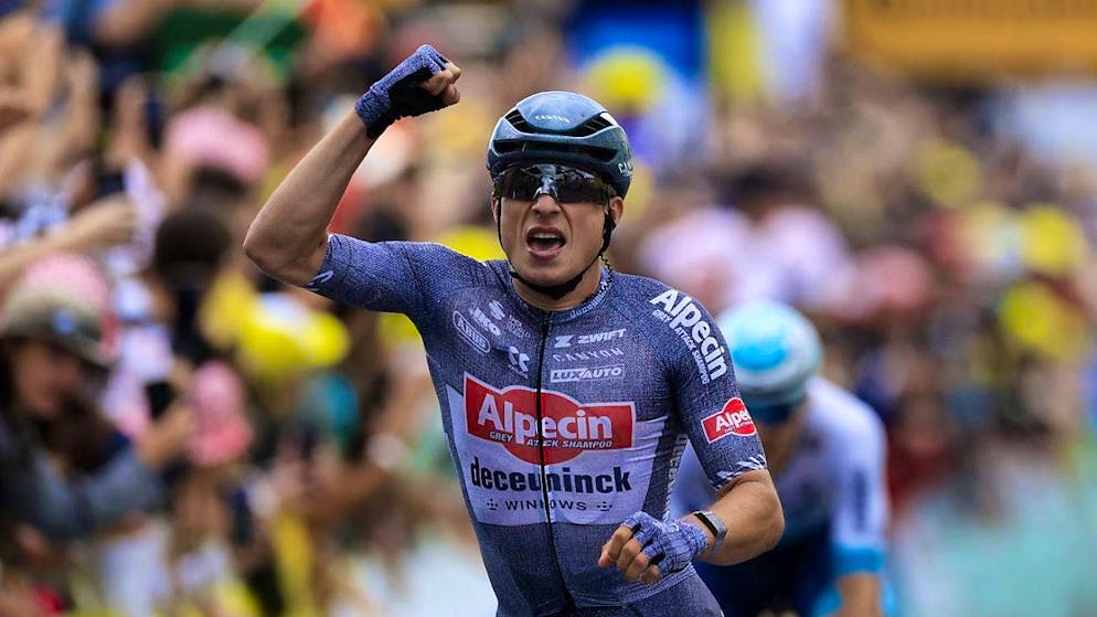 Done: Jasper Philipsen strikes a pose as he crosses the finish line