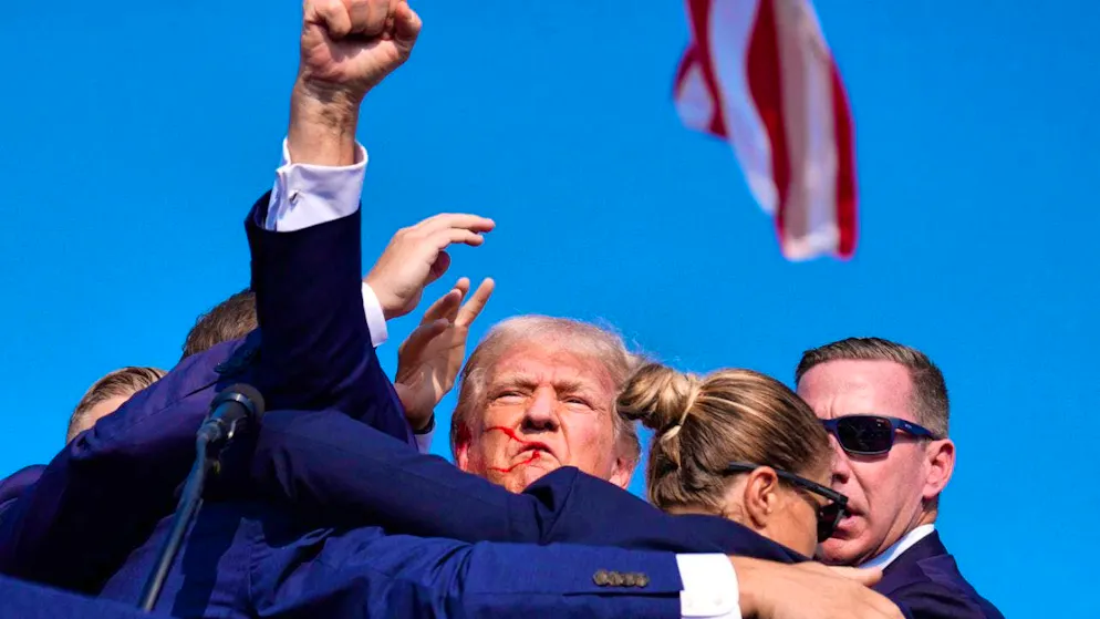 Republican presidential candidate and former President Donald Trump is surrounded by US Secret Service agents at a campaign event in Butler, Pennsylvania, and taken off the stage.