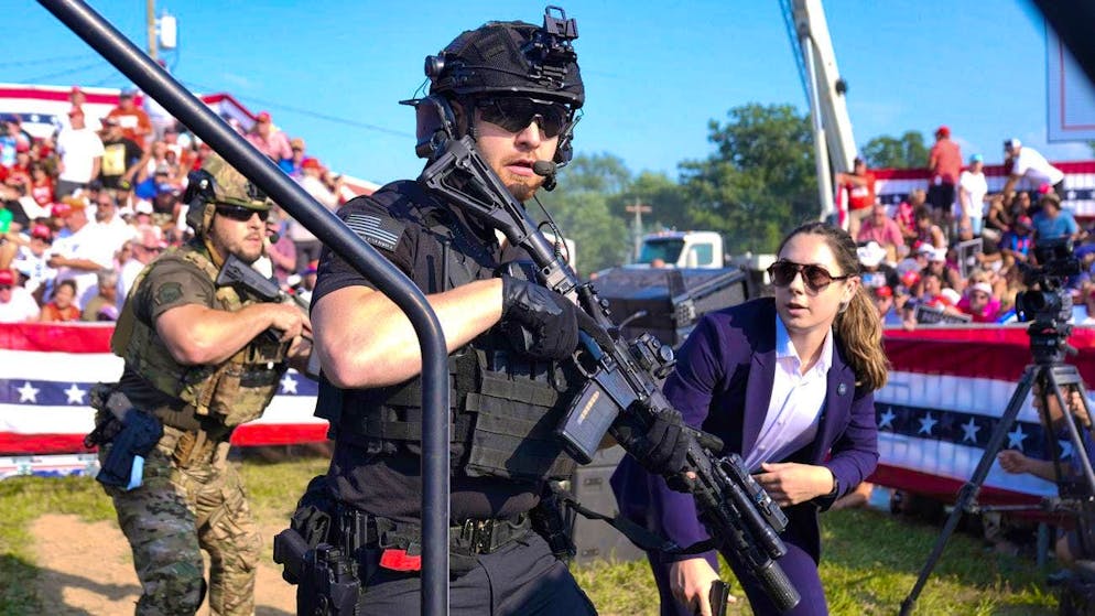 Attack on Trump during US election campaign - suspected shooter dead - Gallery. Secret Service agents run to Trump after shots are fired on stage.