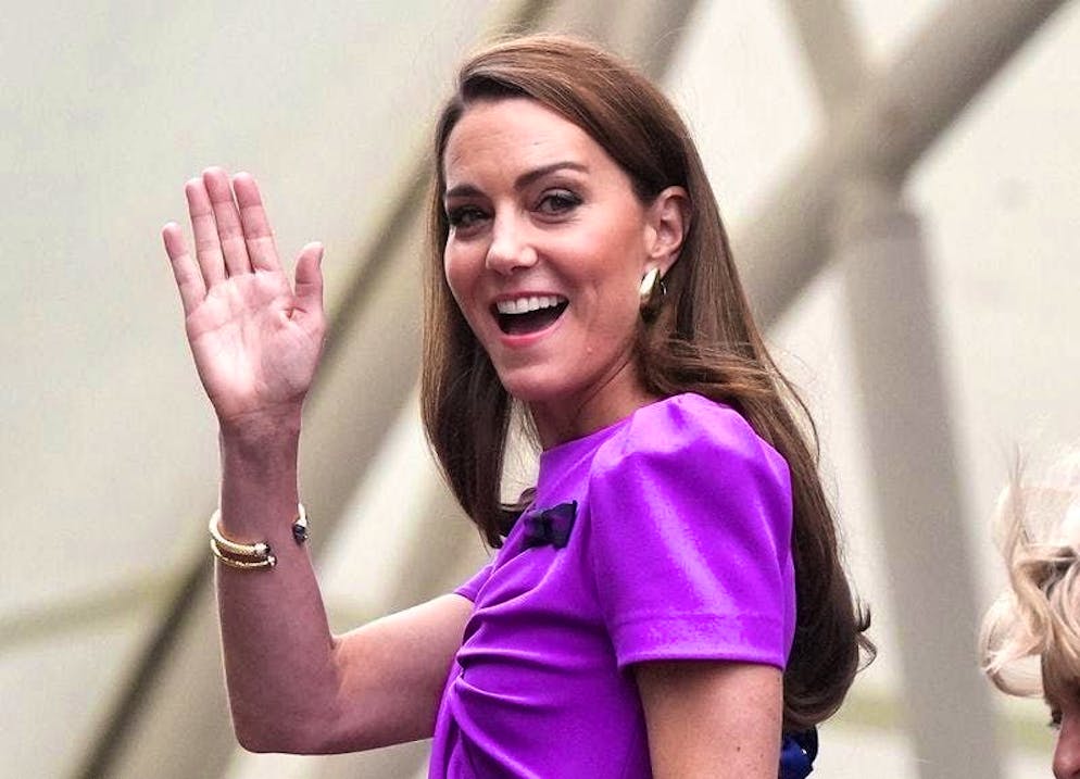 Kate, Princess of Wales, waves on her way to Center Court before the final.