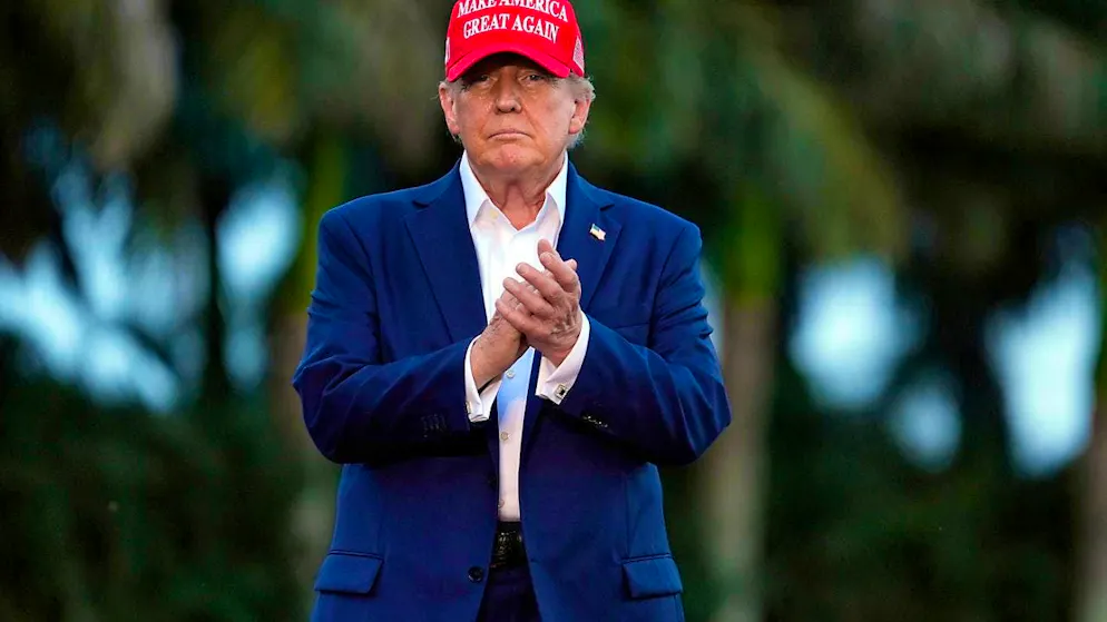 Former US President Donald Trump arrives at a campaign event.