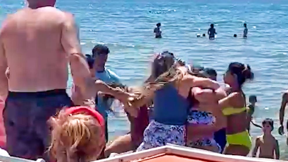 Escalation on a popular vacation beach. Women fight over deck chairs in Italy for 30 minutes