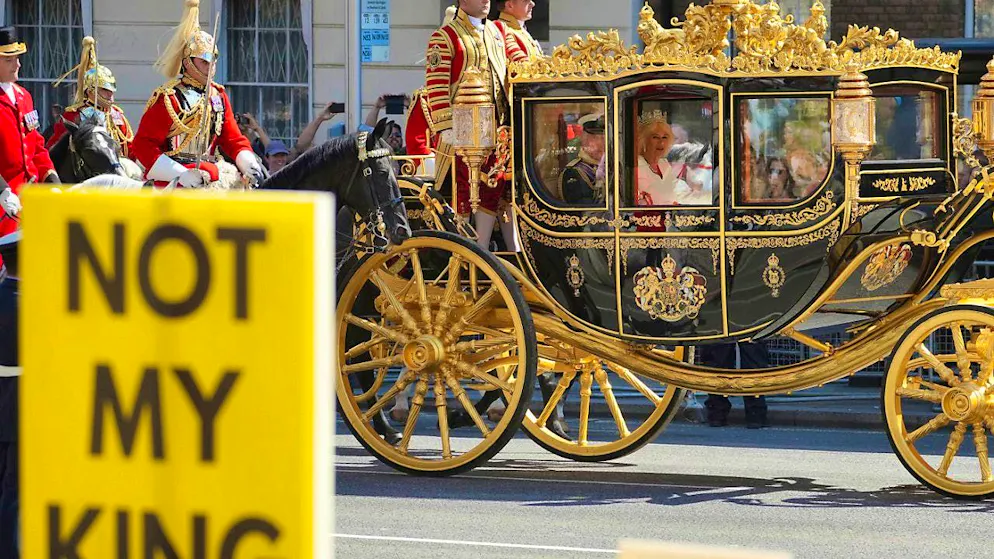 Anti-monarchy protesters demonstrate under the slogan "Not My King" as King Charles III and Queen Camilla drive past in their carriage before the opening of Parliament at the House of Lords in London. Photo: Kin Cheung/AP/dpa