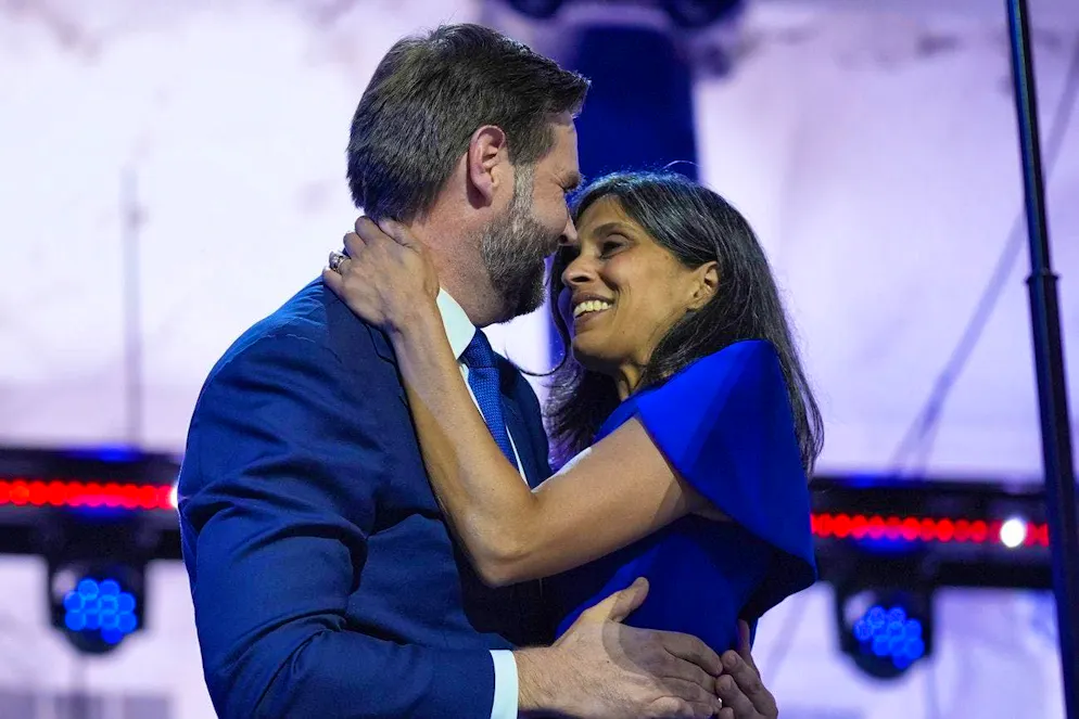 Usha Vance embraces her husband, vice presidential candidate J. D. Vance.