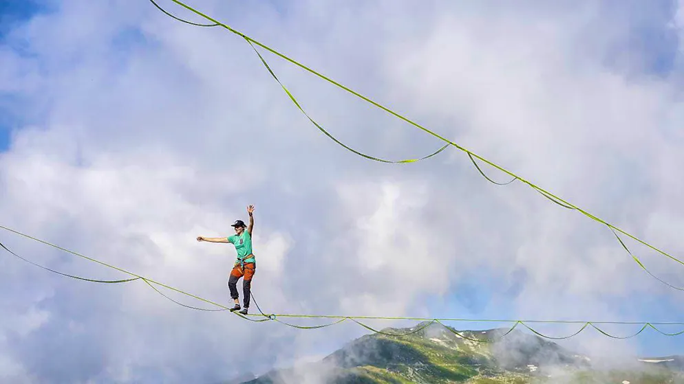 The world's best slackliners compete in Laax - Gallery. The world's 43 best athletes show off their skills 20 meters above the ground.