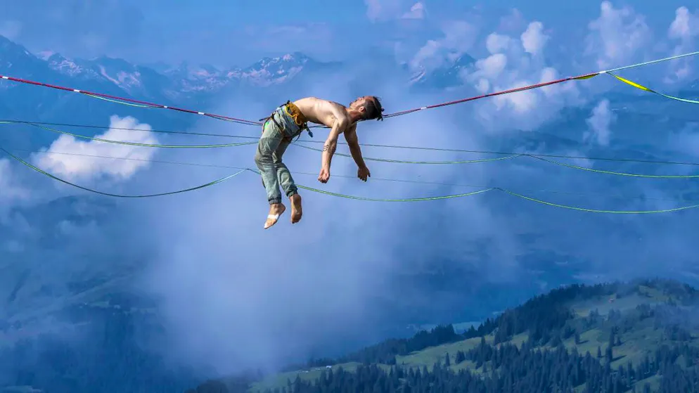 The world's best slackliners compete in Laax - Gallery. Clement Droy, a slackliner from France, warming up during the Slackline World Championships in the Flims Laax ski resort.
