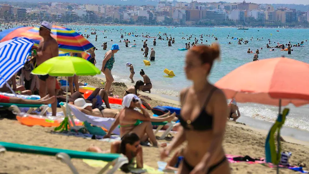 ARCHIVE - People swim and sunbathe on the beach of Arenal on the Mediterranean island of Mallorca. Photo: Clara Margais/dpa