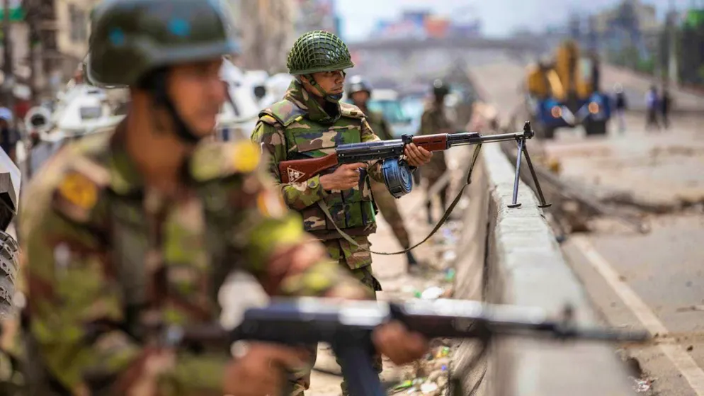 Armed forces stand guard on a street in Dhaka. Photo: Rajib Dhar/AP/dpa