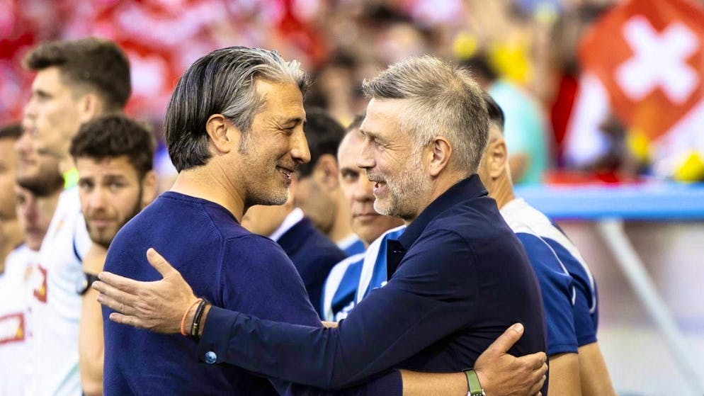 Romania national team coach Edward Iordanescu (right) in conversation with Swiss national team coach Murat Yakin