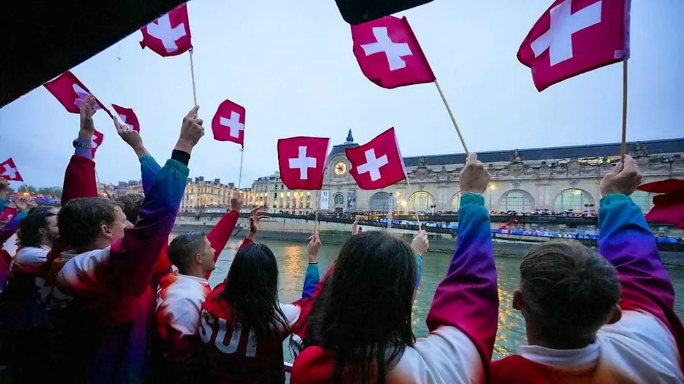 Olympic Opening Ceremony. The Swiss Olympians wave from the boat.