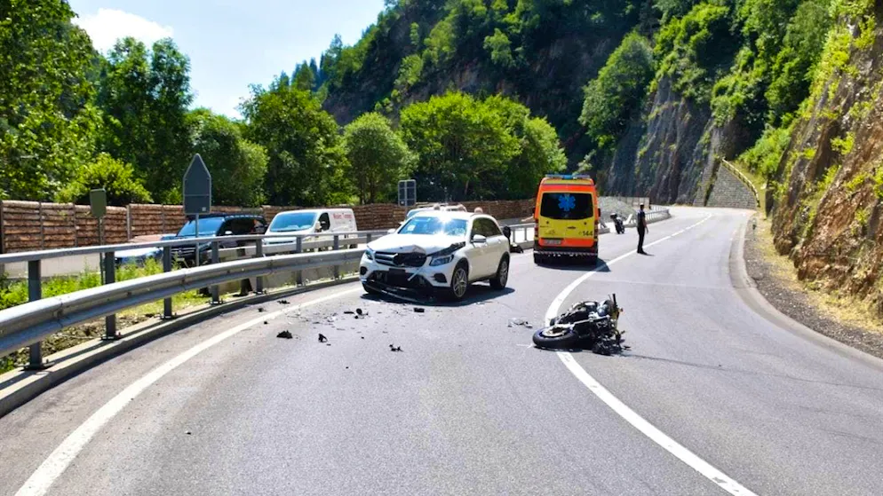 The motorcyclist overshot the center of the road on a right-hand bend and crashed into a car.