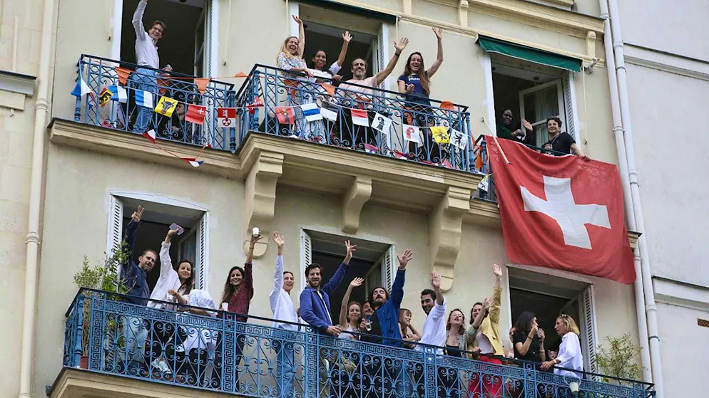 Olympic Opening Ceremony. Swiss sympathizers are also among the spectators on the balconies.