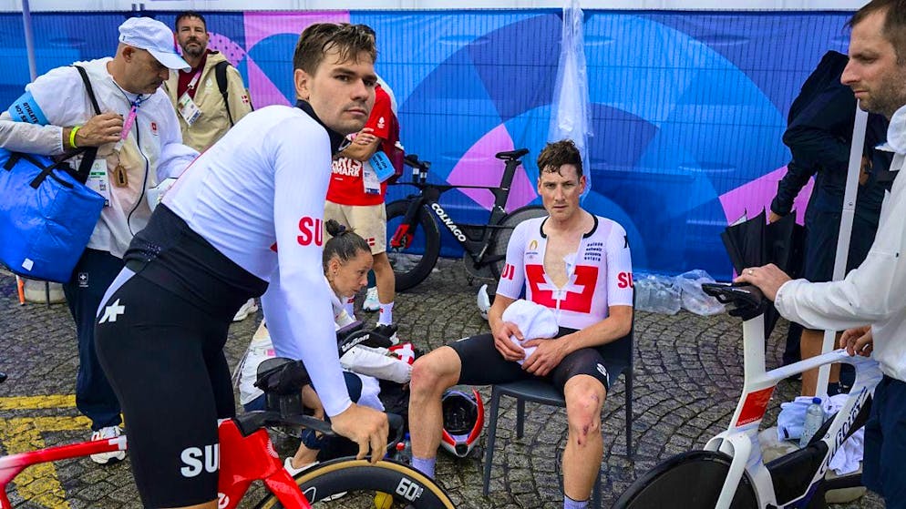 Stefan Küng (seated) and Stefan Bissegger (on the bike) after the Olympic time trial in Paris