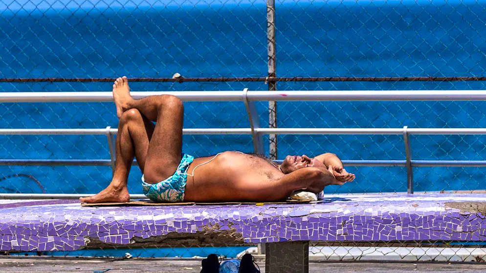 A man sunbathes on the beach promenade in Beirut. Photo: Hassan Ammar/AP/dpa