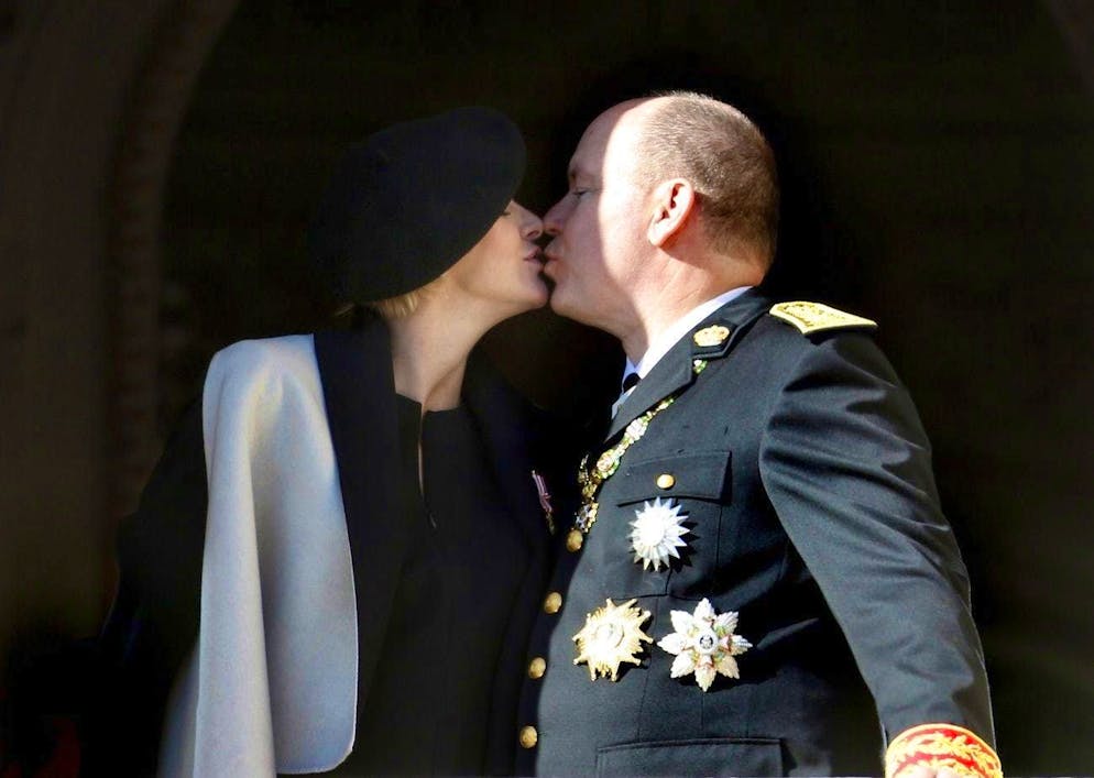 Prince Albert II and Charlène - a love affair with obstacles. A kiss before the army parade for National Day on November 19, 2014.