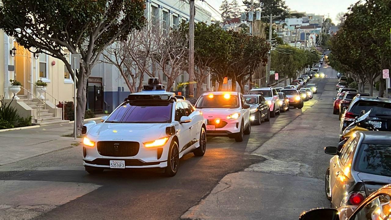 Self-driving cabs. Robotaxi company Waymo stops parking lot honking concerts