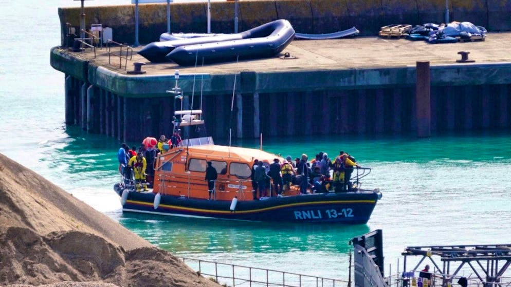 A group of people, believed to be migrants, are brought to Dover after an incident.