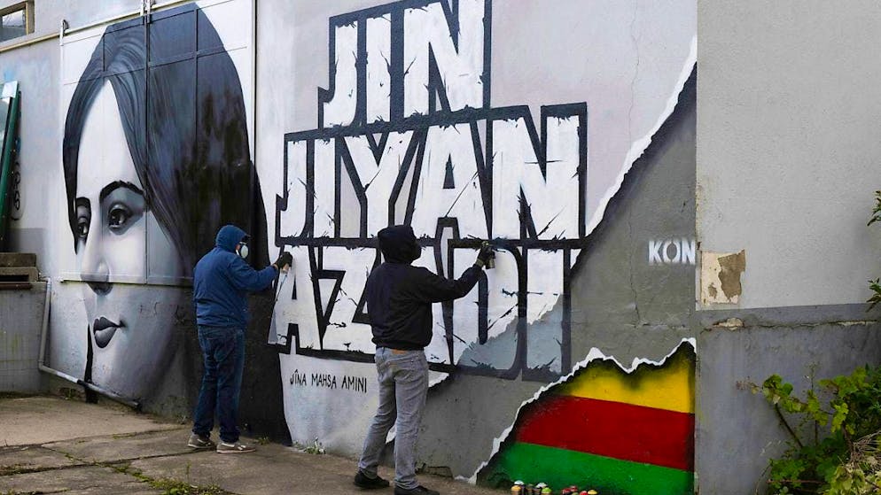 ARCHIVE - Artists from the "Collective without a name" are working on a vacant building to complete a mural for Mahsa Amini, who died in Iran. The death of the 22-year-old has triggered massive protests in Iran. Photo: Boris Roessler/dpa