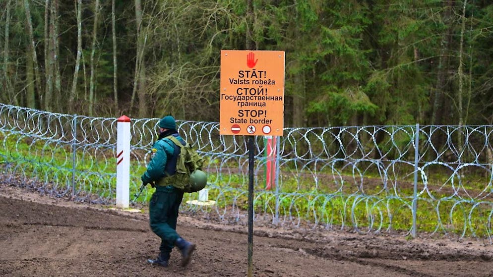 ARCHIVE - "Stop - state border" is written in three languages on the border between Latvia and Belarus. Photo: Alexander Welscher/dpa