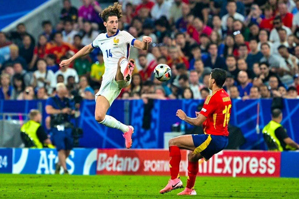 France's Adrien Rabiot (l) and Spain's Rodri fight for the ball in the European Championship semi-final.