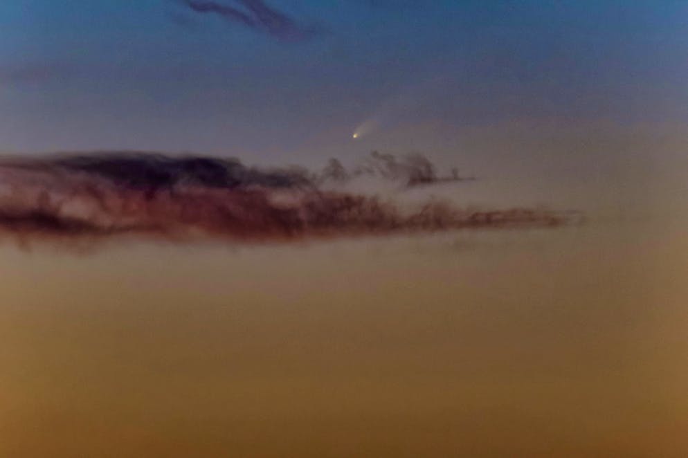 The comet Tsuchinshan-ATLAS appears in the sky above Molfetta, Italy, on Friday.