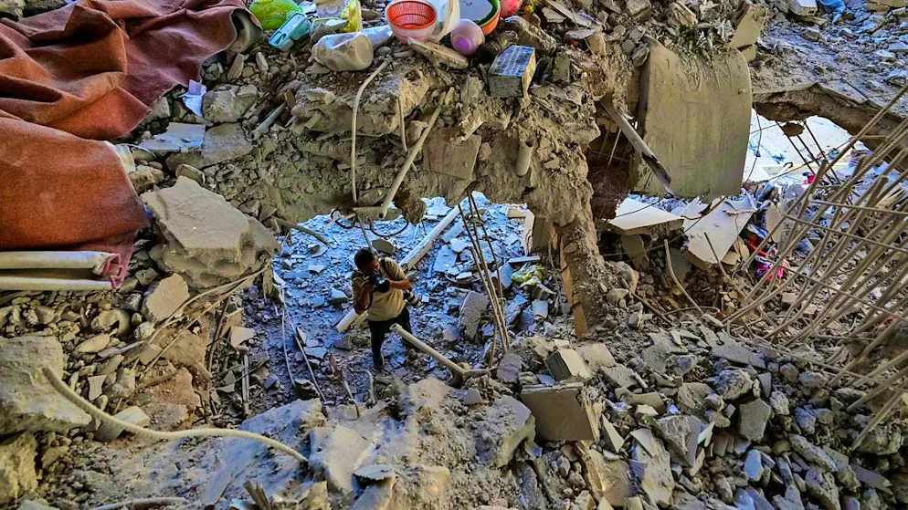 dpatop pictures - A photographer documents the damage in a building hit by an Israeli airstrike in a southern suburb of Beirut. Photo: Hassan Ammar/AP/dpa