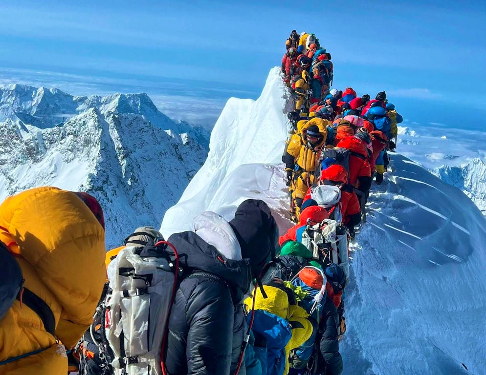 Mountaineers and mountain guides stand in a traffic jam between the South Summit and the Hillary Step of Mount Everest on May 21.