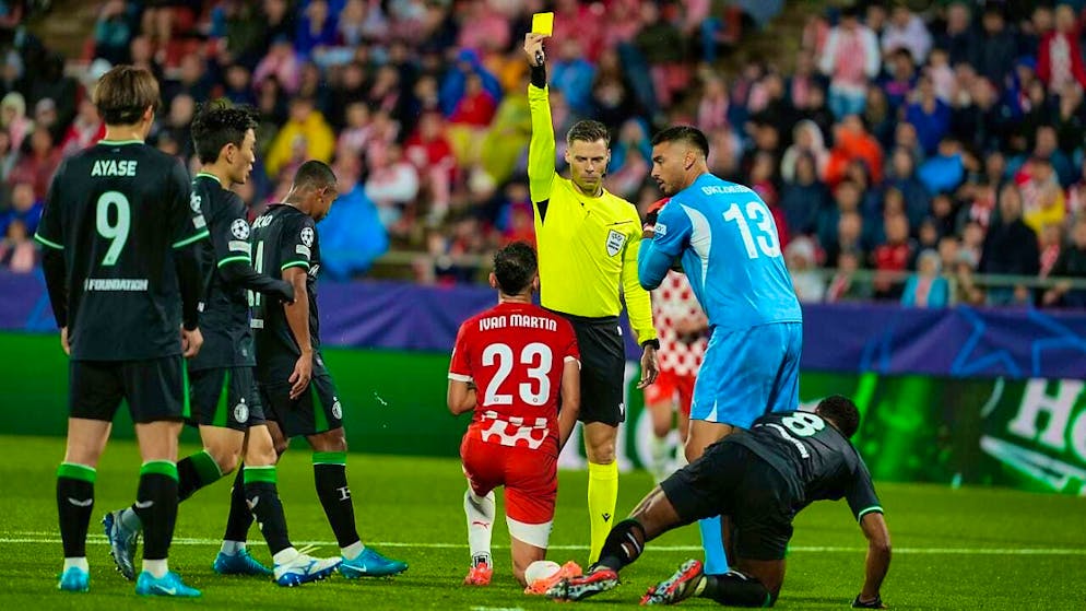Swiss referee Urs Schnyder keeps his eye on the ball in his Champions League debut