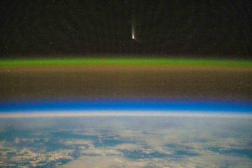 Comet C2023-A3, or Tsuchinshan-ATLAS, was captured at a distance of 99.4 million miles from Earth by NASA astronaut Matthew Dominick using long-exposure photography with a camera programmed for high sensitivity on board the International Space Station.