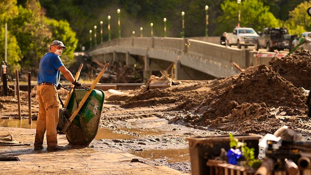 Brian McCormack takes a break after using a wheelbarrow to clear debris after Hurricane Helene in Marshall, N.C. Photo: Jeff Roberson/AP/dpa