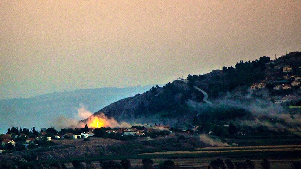 Smoke rises from the Israeli border settlement of Mutella after rocket attacks by Hezbollah. Photo: Stringer/dpa
