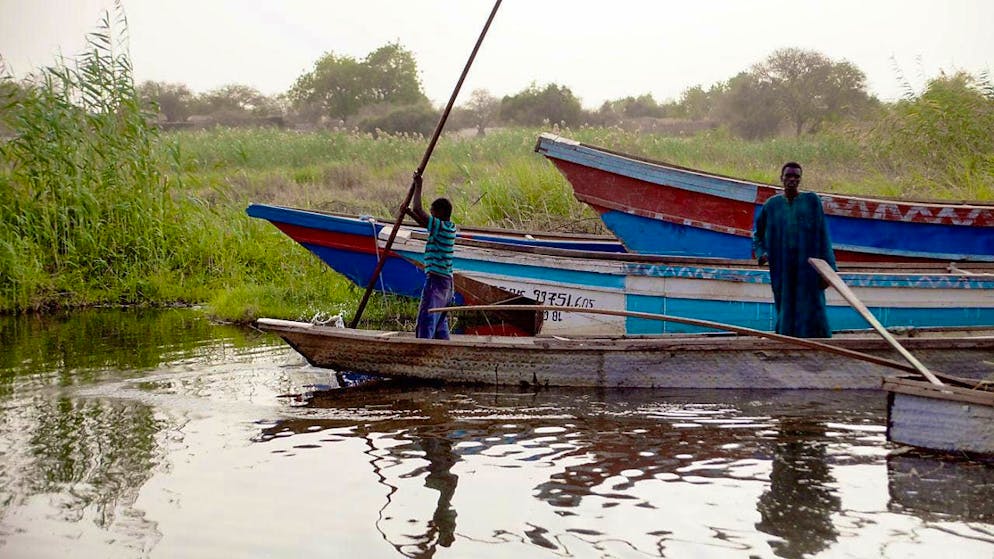 ARCHIVE - A fisherman and his son moor a pirogue on Lake Chad in Baga Sola (Chad). Photo: Kristin Palitza/dpa