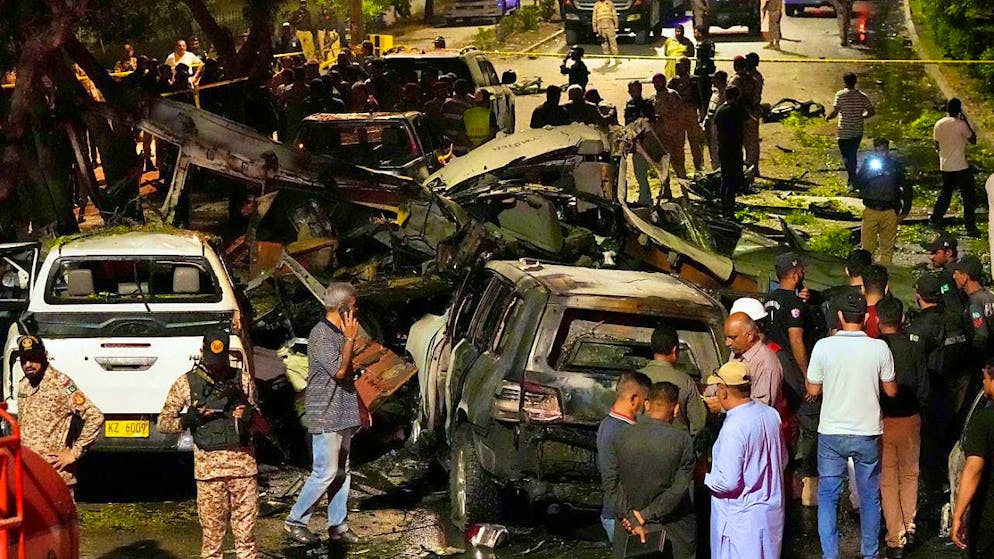 Security officials work at the site of an explosion. Pakistani Baloch separatists claim responsibility for a deadly bomb attack that killed two Chinese near Karachi airport. Photo: Fareed Khan/AP
